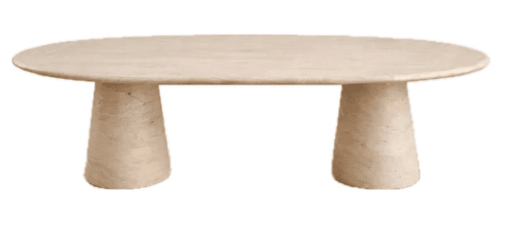 An oval-shaped coffee table crafted entirely from light beige travertine stone, featuring a flat tabletop supported by two stout, cylindrical, slightly conical pedestal bases. The design is minimalist and sculptural. — 3D model