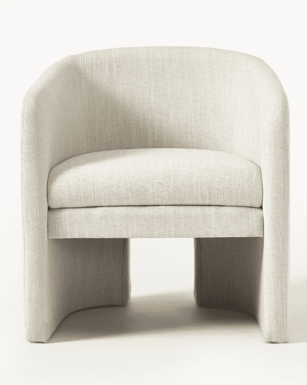 A cream-colored armchair with a curved, barrel-shaped back and arms that seamlessly transition into… — 3D model