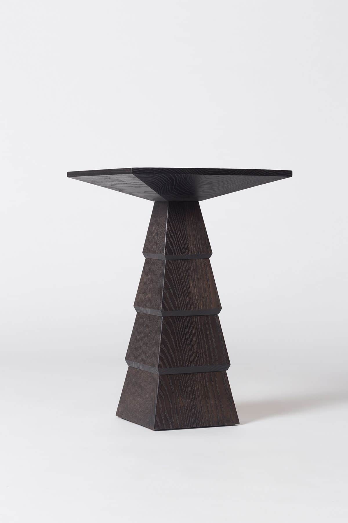 A contemporary dark stained wood pedestal table featuring a distinctive geometric base composed of s… — free STL 3D model