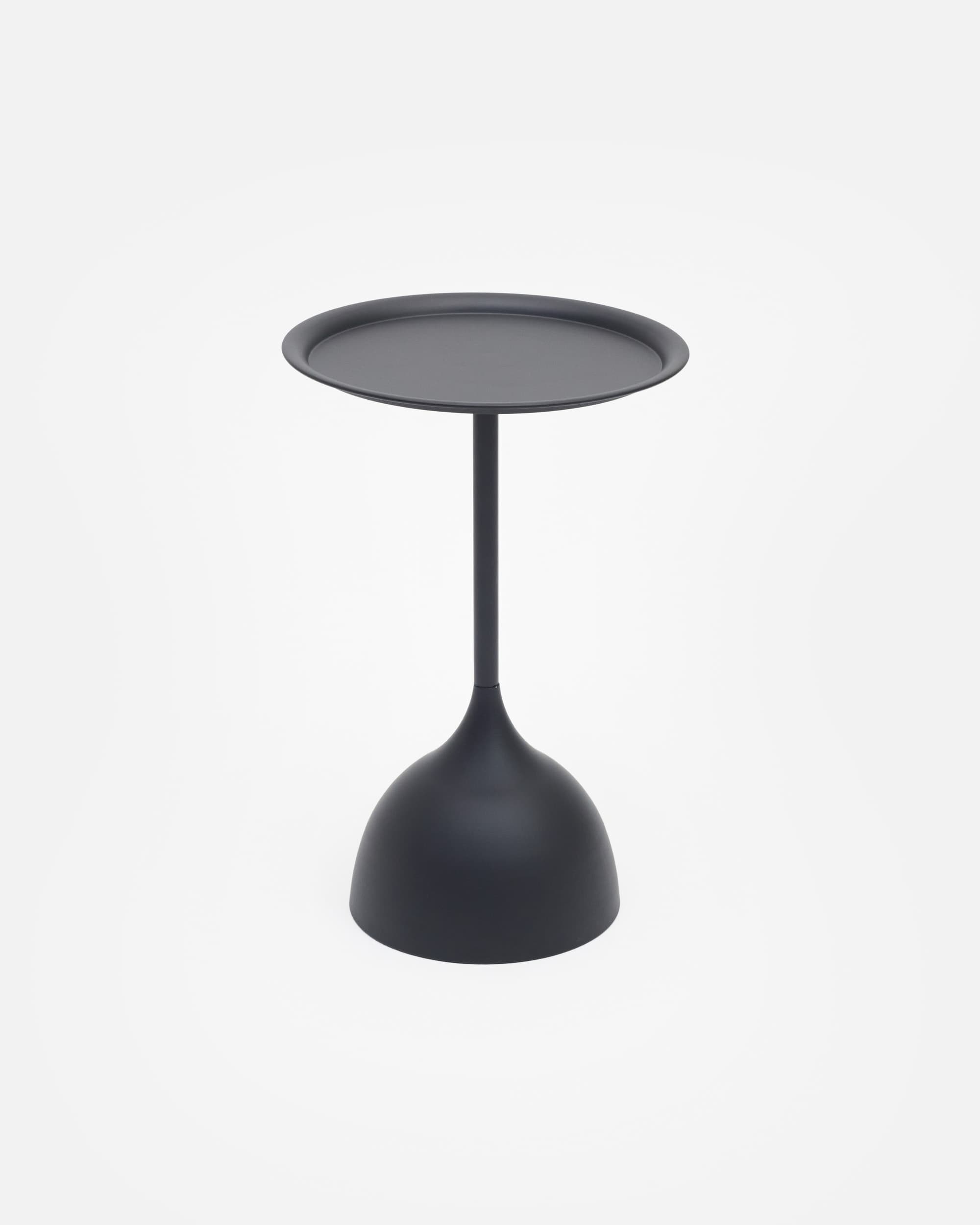 A modern, minimalist drink table in matte black. It features a round, tray-like top with a raised edge, supported by a slender central stem that connects to a distinctive bell-shaped base. The entire piece is monochromatic, with a smooth, non-reflective finish. — 3D model
