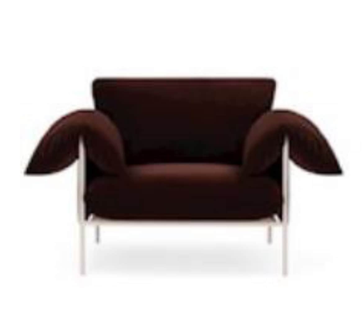 A modern lounge chair featuring a minimalist white metal frame and plush, dark brown fabric cushions… — free OBJ 3D model