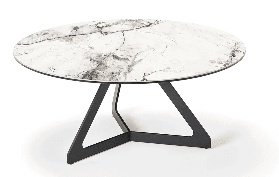 A contemporary round coffee table featuring a white tabletop with realistic grey and brown marble-like veining. The top is supported by a distinctive matte black metal base, designed with intersecting geometric shapes that create an open, sculptural form. — 3D model