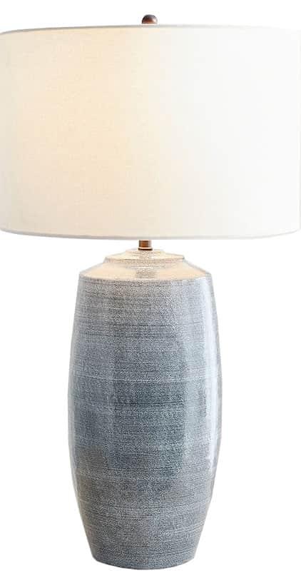 A table lamp featuring a cylindrical ceramic base with a distressed, textured grey-blue finish, topp… — 3D model