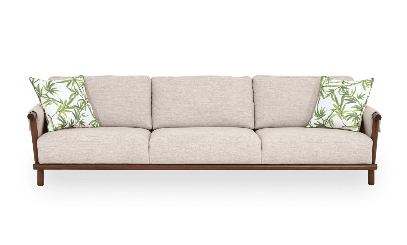 A three-seater sofa featuring a light beige fabric upholstery and an exposed dark-stained wooden frame. It includes three seat cushions, three back cushions, and two decorative pillows with a green botanical pattern. — 3D model