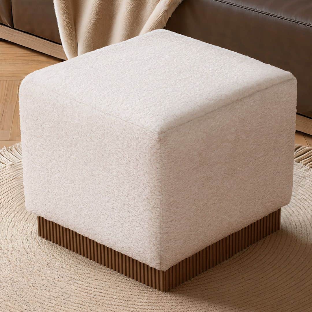 A square upholstered ottoman with gently rounded top edges, covered in an off-white bouclé-textured… — free STL 3D model