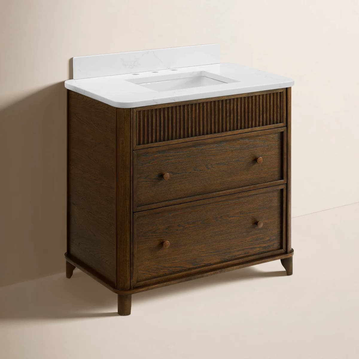 A freestanding single-sink bathroom vanity featuring a dark wood cabinet, a white marble-look countertop with an integrated rectangular sink, and a matching backsplash. The cabinet's upper section includes reeded paneling, while the lower section consists of two full-width drawers with round wooden knobs. The vanity is supported by four tapered legs. — 3D model