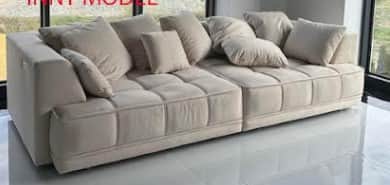 A modular sectional sofa with a low profile. It features a light-colored fabric upholstery with a tu… — free OBJ 3D model