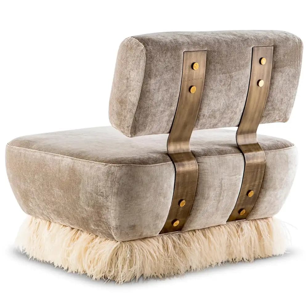 An armless lounge chair with a plush, low-profile design. It features taupe-colored velvet upholstery for the seat and backrest. The backrest is supported by two arching brass-toned metal straps, secured with decorative brass studs. The chair rests on a distinctive plinth base covered in shaggy, off-white faux fur, adding a luxurious and textural element to its contemporary design. — 3D model