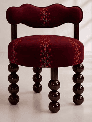 A compact, upholstered decorative accent chair featuring a distinctive burgundy velvet-like fabric.… — 3D model