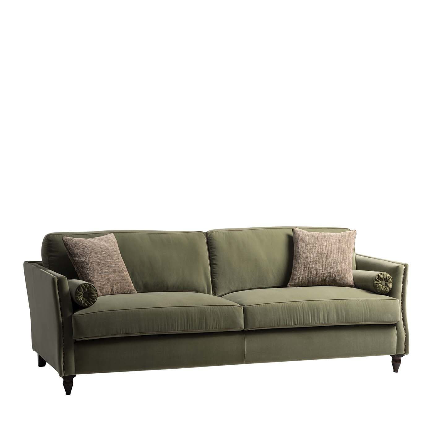 A plush, three-seater sofa upholstered in a deep olive-green fabric. The sofa features a high back and rolled armrests, with decorative nailhead trim along the base and arms. It is supported by short, dark wooden legs. Two rectangular throw pillows with a textured pattern in muted brown and grey tones are placed on the sofa, along with a smaller cylindrical bolster pillow on each armrest. — 3D model