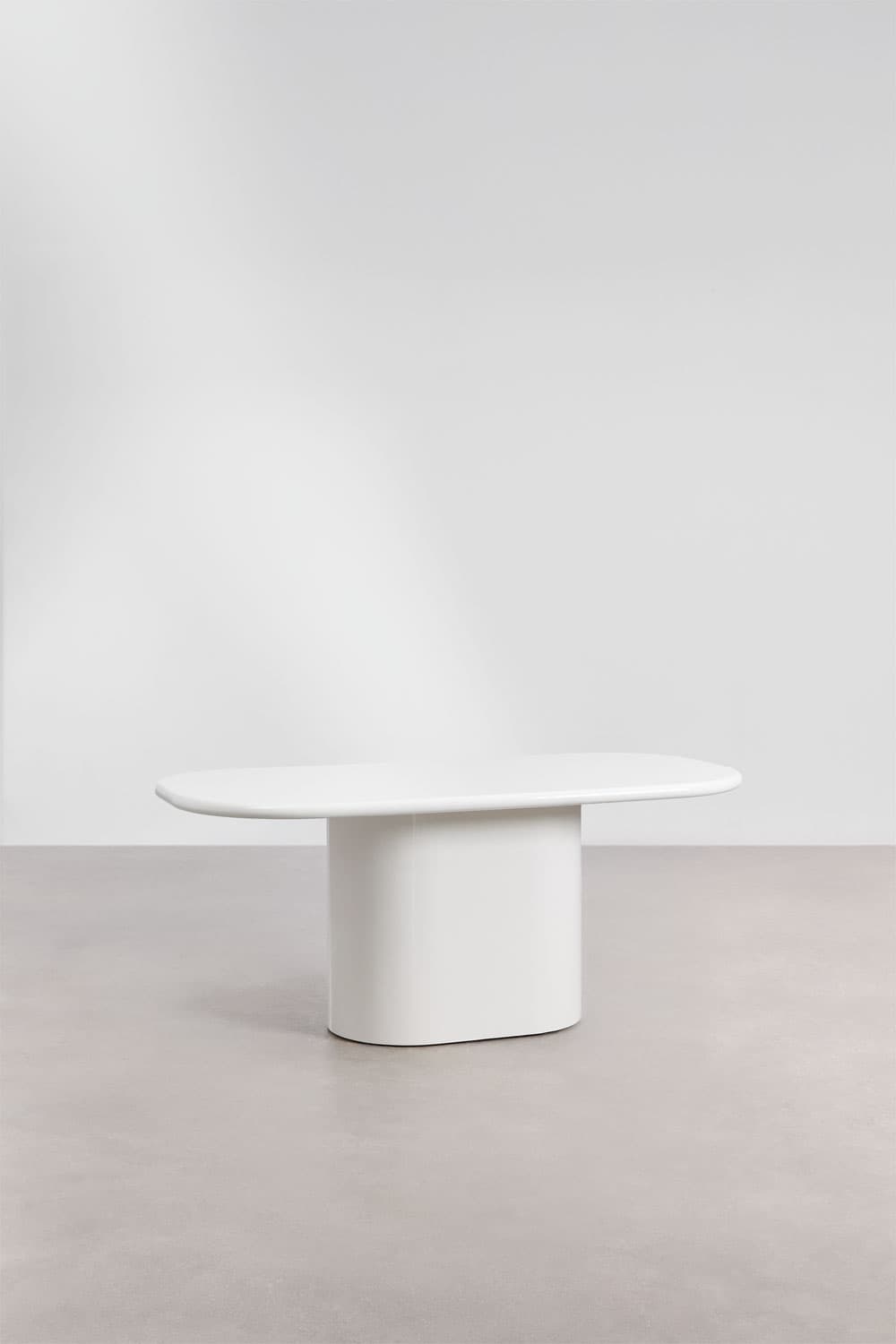 A white minimalist coffee table with a capsule-shaped tabletop and a central, pill-shaped pedestal base. The design is monolithic, featuring smooth, rounded edges and a seamless finish, suggesting a contemporary aesthetic. — 3D model