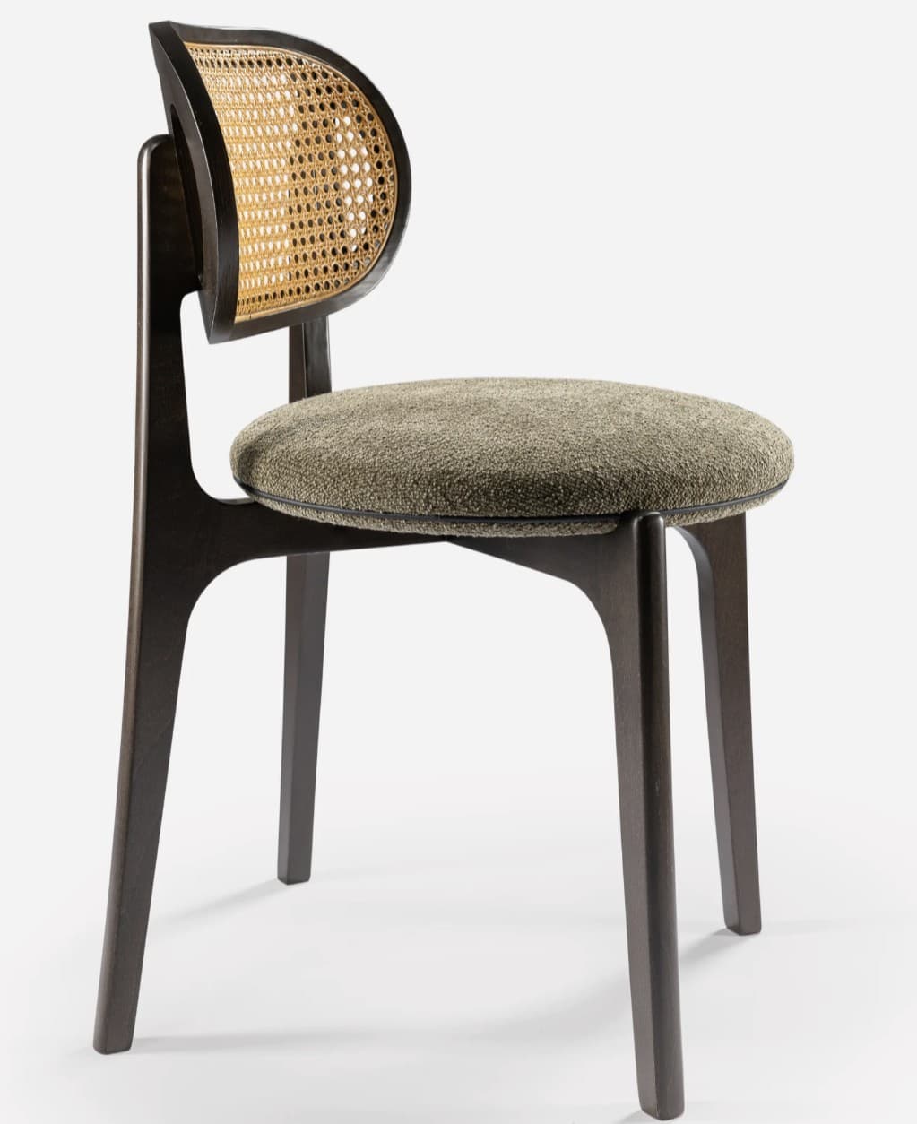 A modern side chair featuring a dark wooden frame with a distinctive curved backrest. The backrest incorporates a woven cane panel. The seat is upholstered in a textured, neutral-toned fabric. The legs are tapered and angled outwards, contributing to a sleek silhouette. — 3D model