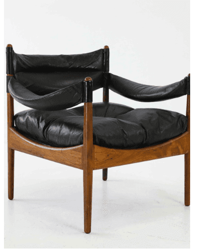 A mid-century modern armchair with a wooden frame and black leather upholstery. The chair features a… — free OBJ 3D model
