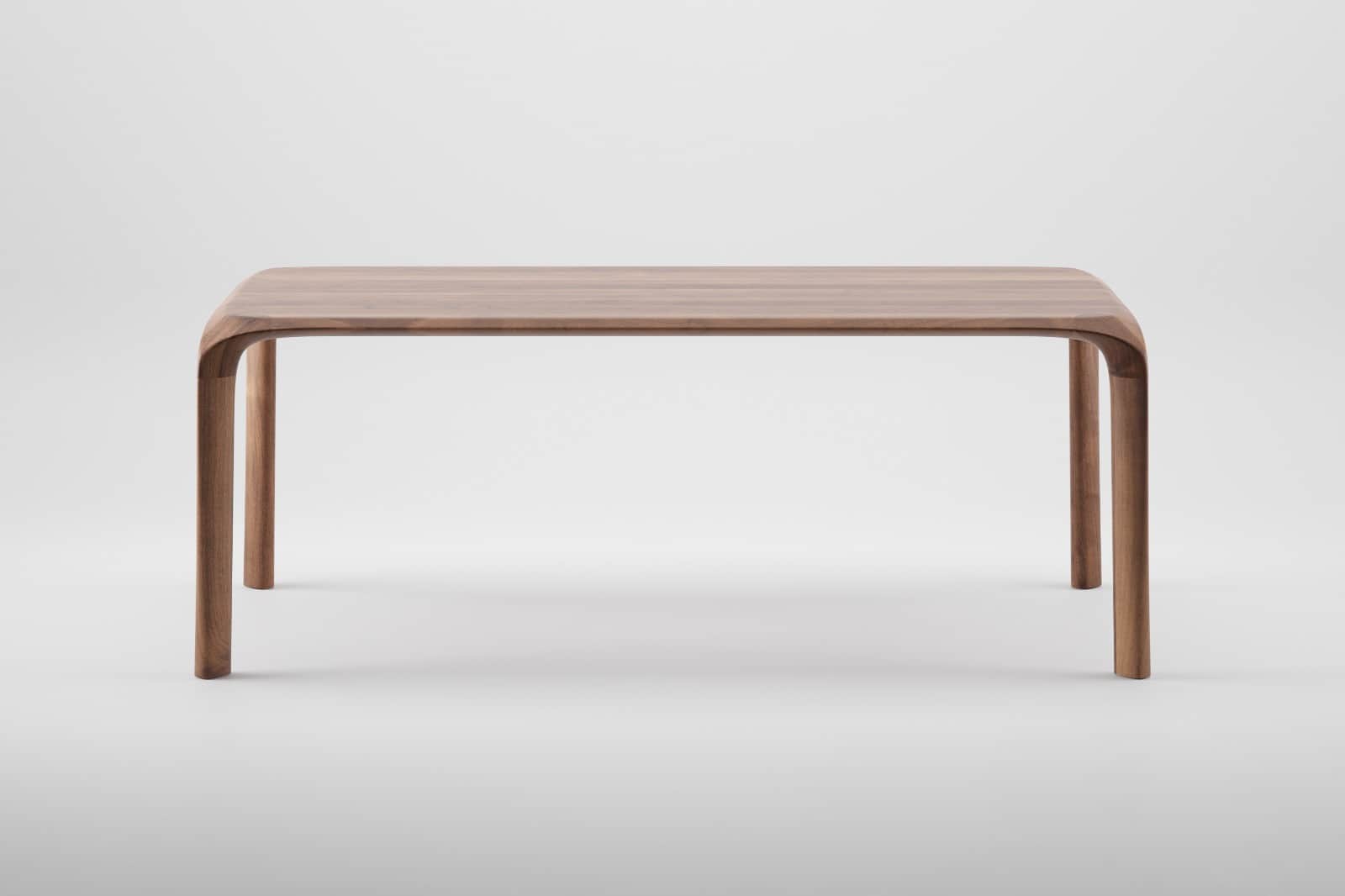 A rectangular solid wood table with smoothly rounded corners and legs that are seamlessly integrated… — free OBJ 3D model