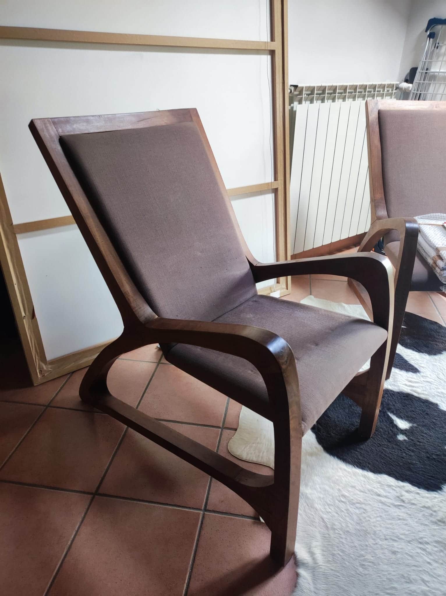 A modern lounge chair featuring a dark-stained solid wood frame with elegantly curved armrests and b… — free BLEND 3D model