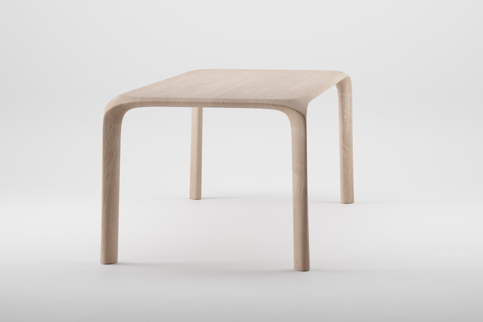 A minimalist side table crafted from light-colored solid wood, likely oak or ash. It features a rectangular tabletop with softly rounded corners and legs that seamlessly curve from the table's edge, creating a fluid, sculptural silhouette. The design is characterized by its smooth lines and natural finish, emphasizing the wood's grain and sophisticated construction. — 3D model