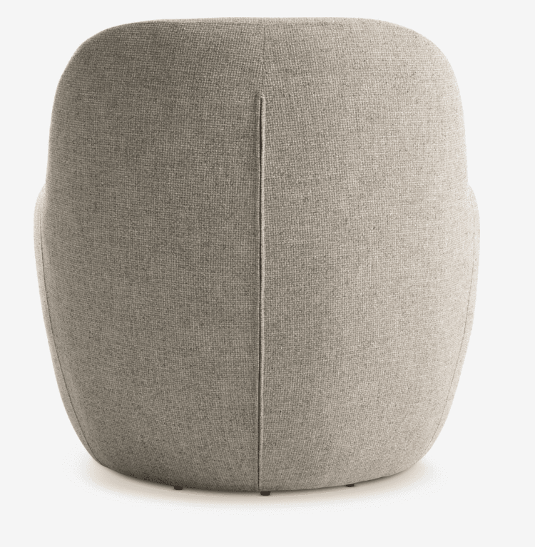 The image displays the back view of a contemporary upholstered barrel armchair. It features a continuous, rounded silhouette with a distinct vertical seam running down the center of the backrest. The chair is covered in a light beige or greige textured woven fabric. The design appears compact and minimalist, with a smoothly curved form that suggests an enveloping, comfortable seat. Small glides or feet are barely visible at the very bottom edge. — 3D model