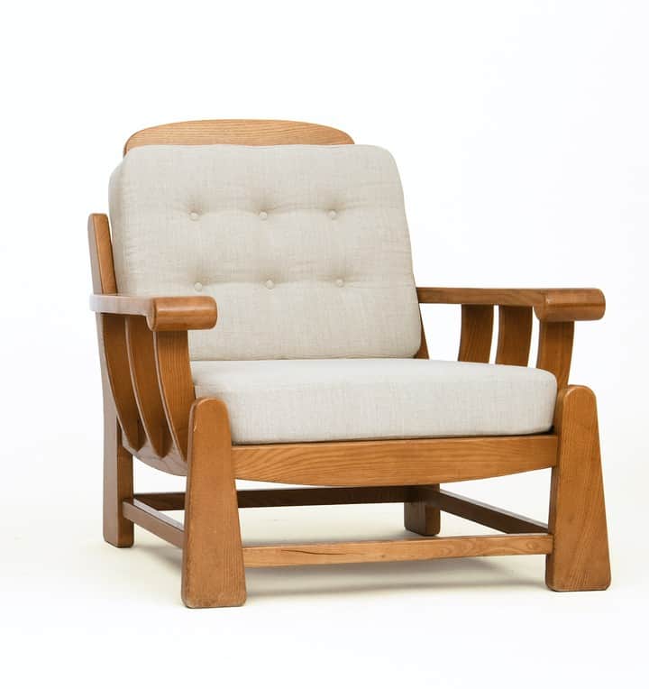 A sturdy, craftsman-style lounge chair featuring a solid oak wood frame and thick, upholstered cushi… — 3D model