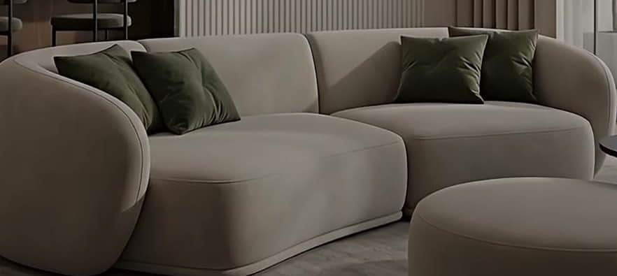 A modern, curved sectional sofa upholstered in a light beige fabric, accompanied by a matching round… — 3D model