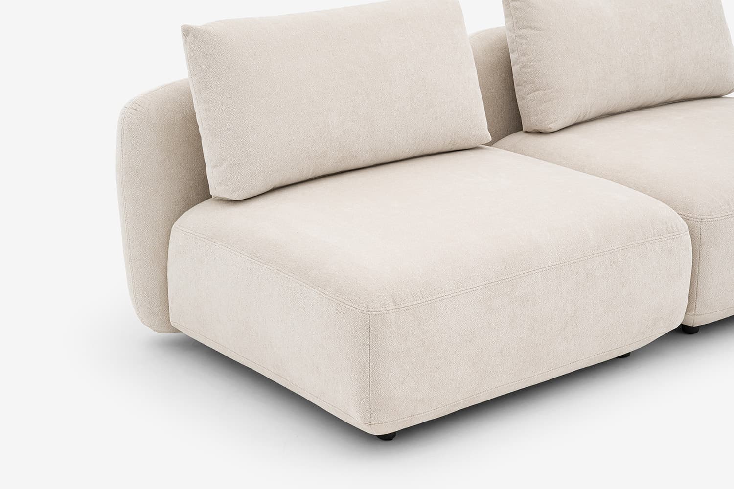 A sectional sofa unit with a low profile, upholstered in a textured, light-colored fabric. The design features rounded armrests and seat cushions, with a modular appearance. Visible stitching details indicate precise construction. The sofa has a contemporary, minimalist aesthetic. — 3D model