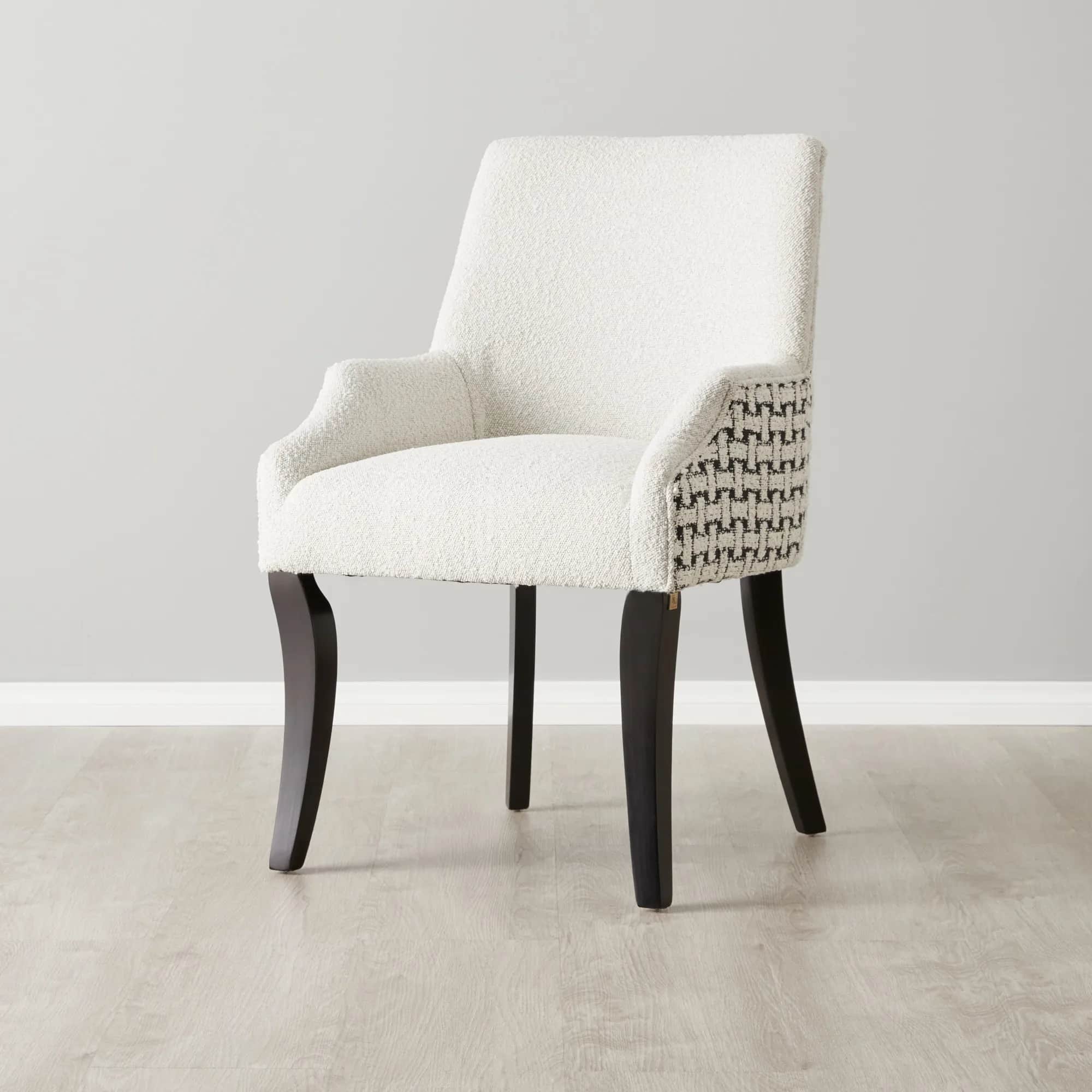 A white upholstered accent chair with a boucle texture on the seat and back, and a geometric pattern… — 3D model