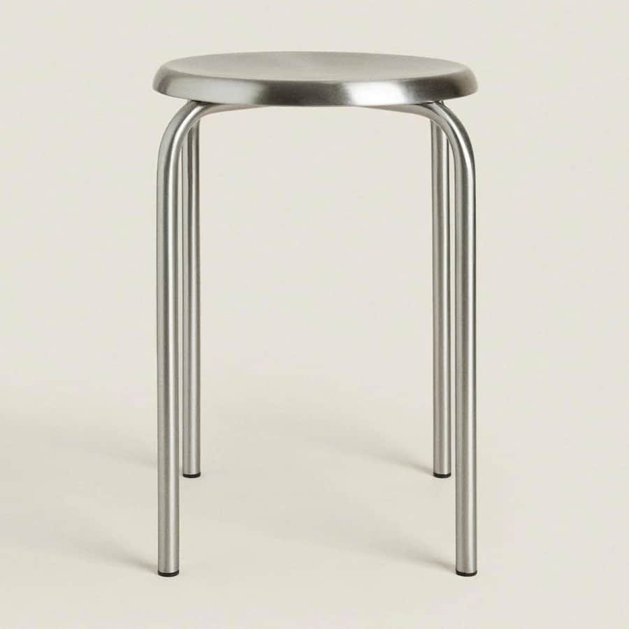 A contemporary stool featuring a circular, brushed metal seat and three cylindrical legs connected b… — free SKP 3D model