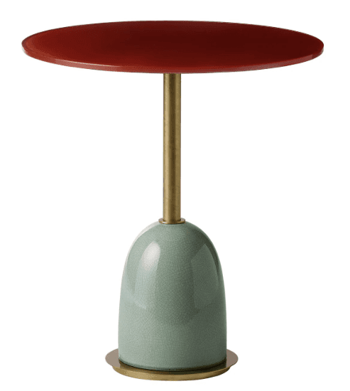 A small, contemporary accent table featuring a round, dark red top supported by a slim brass-toned m… — 3D model
