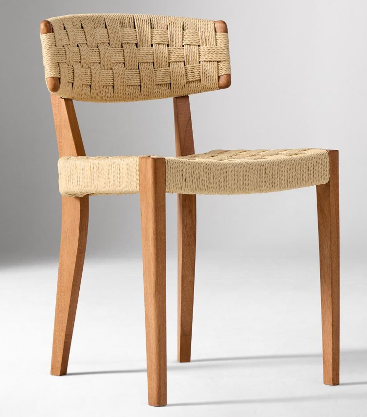 A side chair with a woven rush seat and backrest, supported by a wooden frame. The seat and back are constructed with a tightly woven pattern of natural fibers. The frame consists of four tapered legs and a simple back support structure, all made of light-colored wood. — 3D model