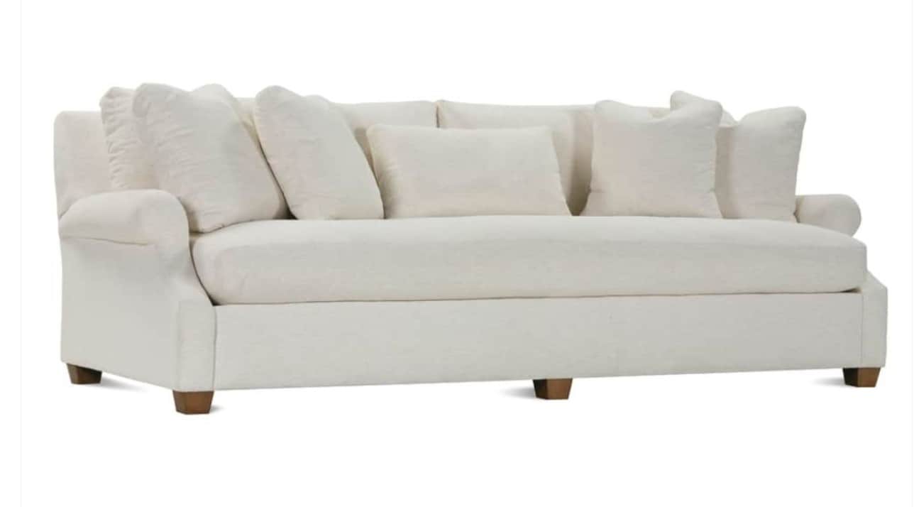 A contemporary sofa featuring a clean, off-white fabric upholstery, rolled arms, and multiple loose… — free STL 3D model