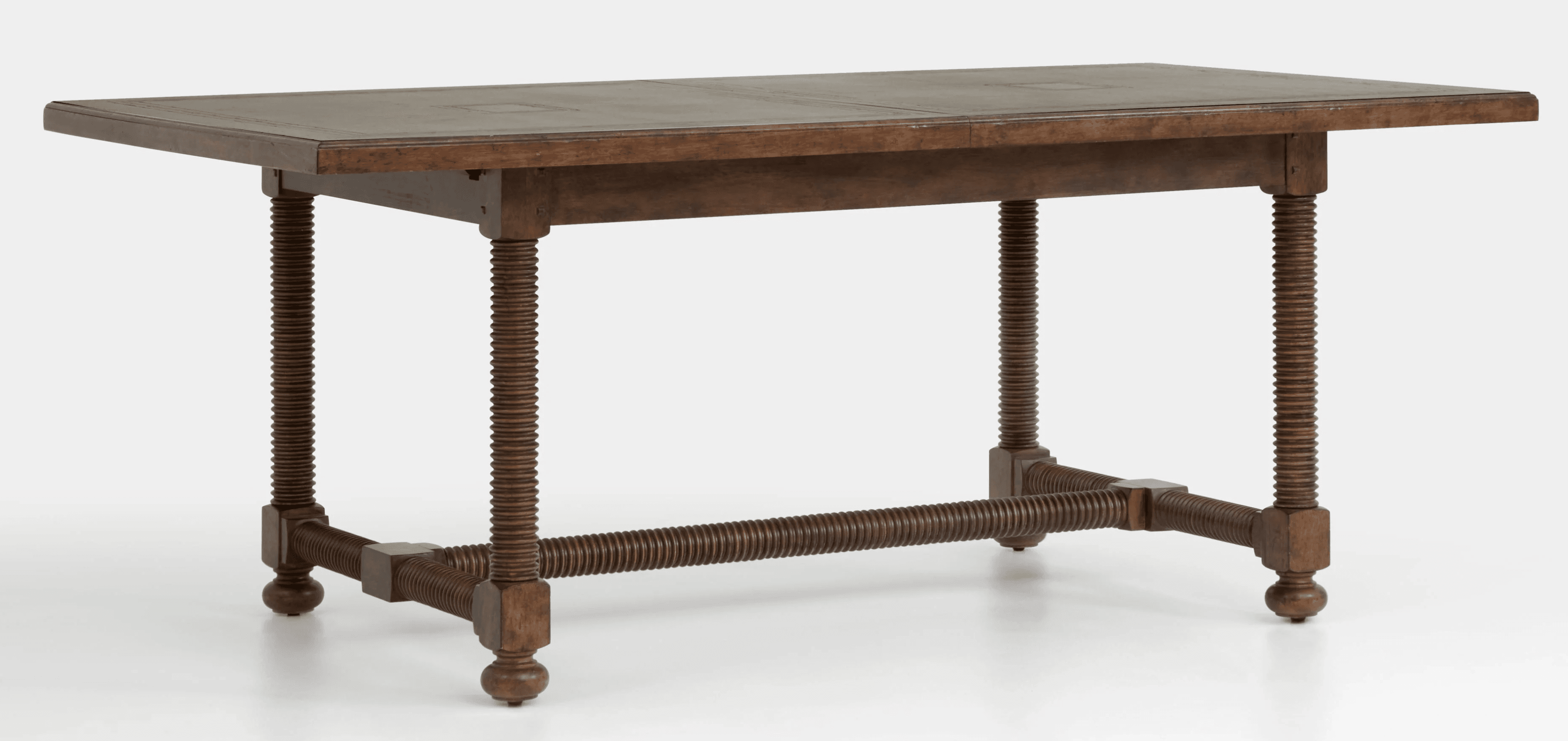 A rectangular dining table with a dark wood finish. The tabletop appears to be composed of multiple panels with subtle inlaid details. The table features four turned legs with a prominent spiral or fluted design. A stretcher bar, also with a spiral design, connects the lower portions of the legs, contributing to the overall structural integrity and aesthetic. The legs terminate in small, rounded feet. — 3D model