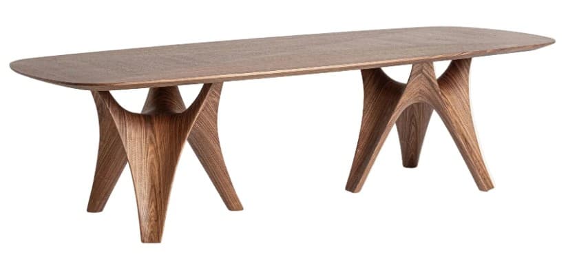 A modern dining table with an elongated, subtly rounded rectangular top. The base consists of two sculptural, interconnected leg structures, each resembling an abstract, curved form that splits into multiple supporting points. The overall design is organic and artistic. — 3D model