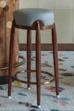 A modern bar stool with a round, upholstered seat and four tapered wooden legs. A circular metal foo… — free SKP 3D model