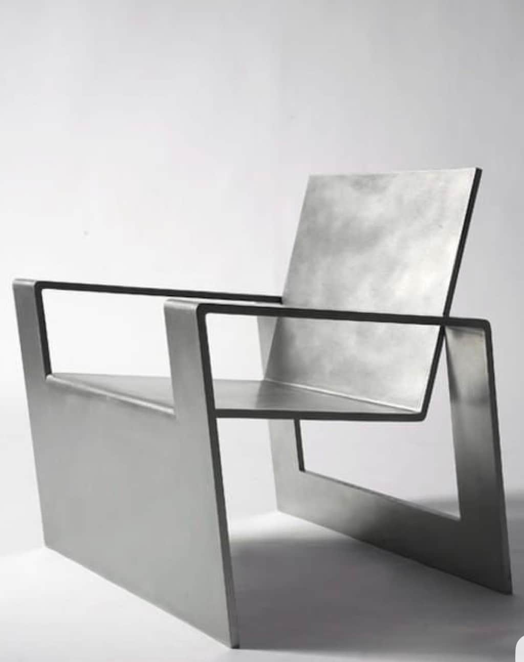 A modern armchair with a minimalist design, constructed from flat metallic planes. It features a low… — free OBJ 3D model