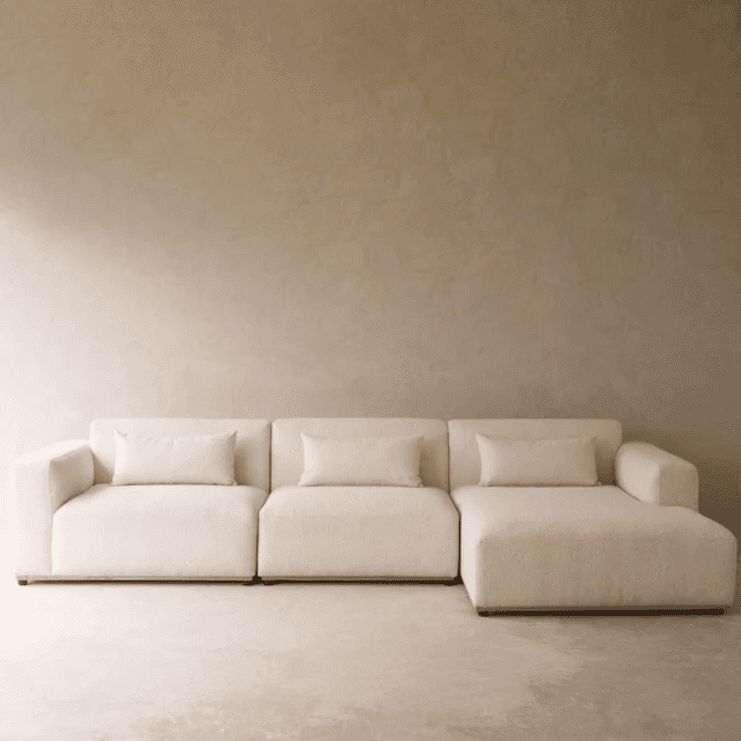 A cream-colored, modern modular sectional sofa composed of multiple units, including a chaise lounge… — 3D model