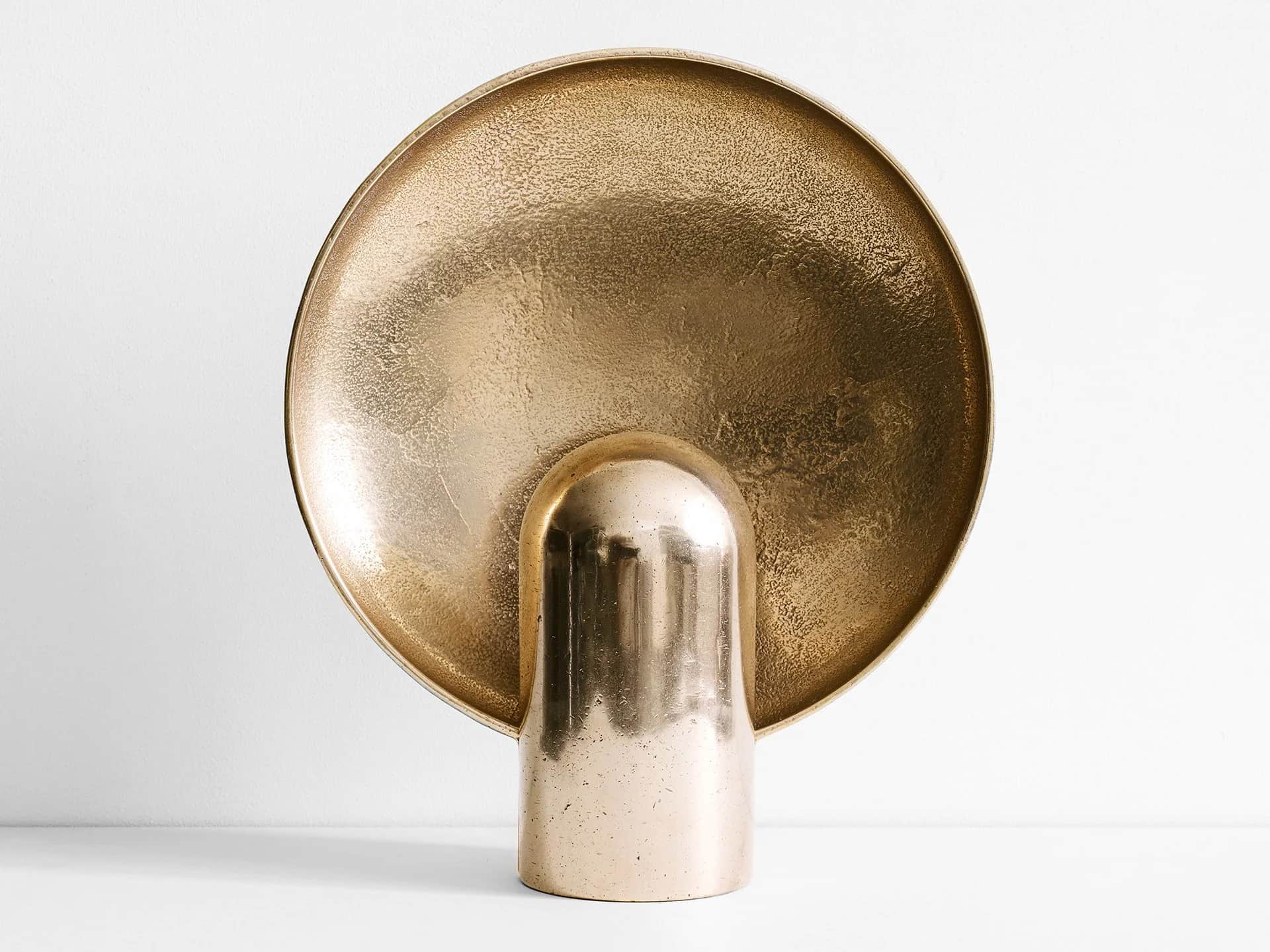 A golden-hued, abstract decorative object made of brass, featuring a large, textured, concave circul… — 3D model