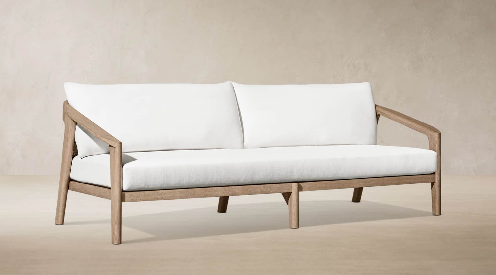 A modern outdoor two-seater sofa featuring a sturdy, light-toned wooden frame and plush white uphols… — 3D model