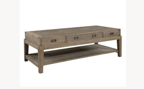 A rectangular coffee table with a lower shelf and three drawers on the front. The table features a rustic or industrial design with metal accents on the corners and drawer pulls. The wood appears to have a natural grain and a weathered finish. — 3D model