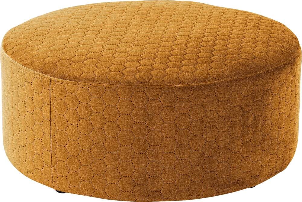A round, upholstered ottoman featuring a distinctive hexagonal quilted pattern across its entire surface. The fabric is a rich mustard yellow or golden brown color, giving it a warm and inviting appearance. It has a low-profile, cylindrical shape with a flat, padded top suitable for sitting or resting feet. — 3D model