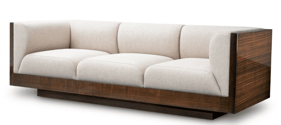 A three-seater modern sofa featuring a substantial exposed dark wood frame that encompasses the base and extends upwards to form the outer armrests. The interior seating area consists of three individual seat cushions and three individual back cushions, all upholstered in a light-colored, possibly cream or off-white, fabric. The wood components exhibit a glossy, rich dark brown finish with prominent grain patterns, suggesting a high-quality veneer. The sofa sits on a low, recessed plinth base, giving it a floating appearance. — 3D model