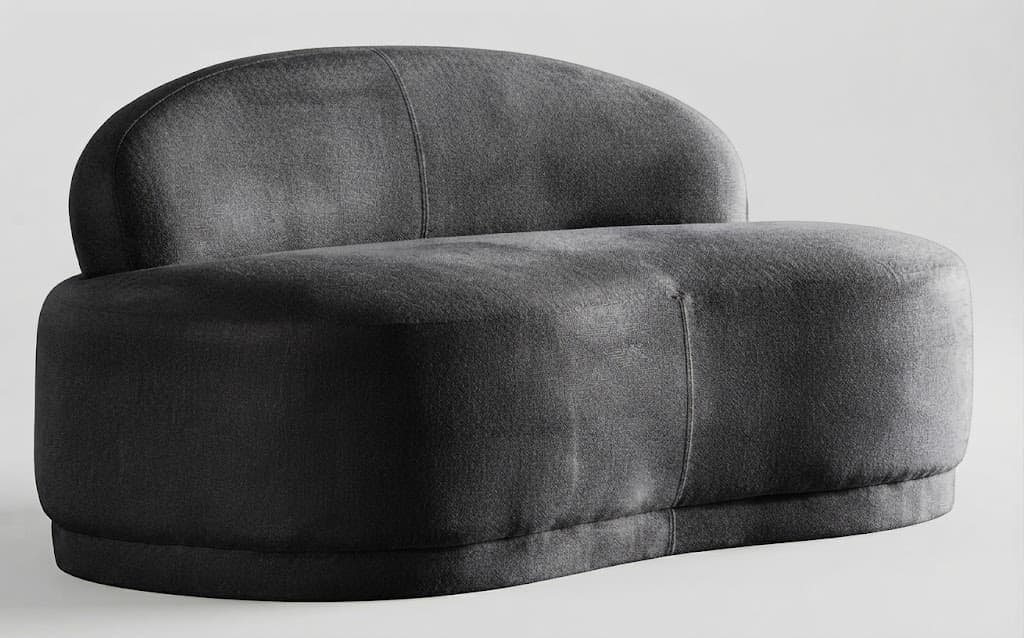 A dark grey upholstered armless lounge chair with a rounded, organic form. It features a low, curved backrest that seamlessly flows into the seat. The entire piece is upholstered in a textured fabric, appearing soft and inviting. The base is also upholstered and slightly recessed, giving the chair a solid, grounded appearance. The design emphasizes comfort and a minimalist aesthetic. — 3D model