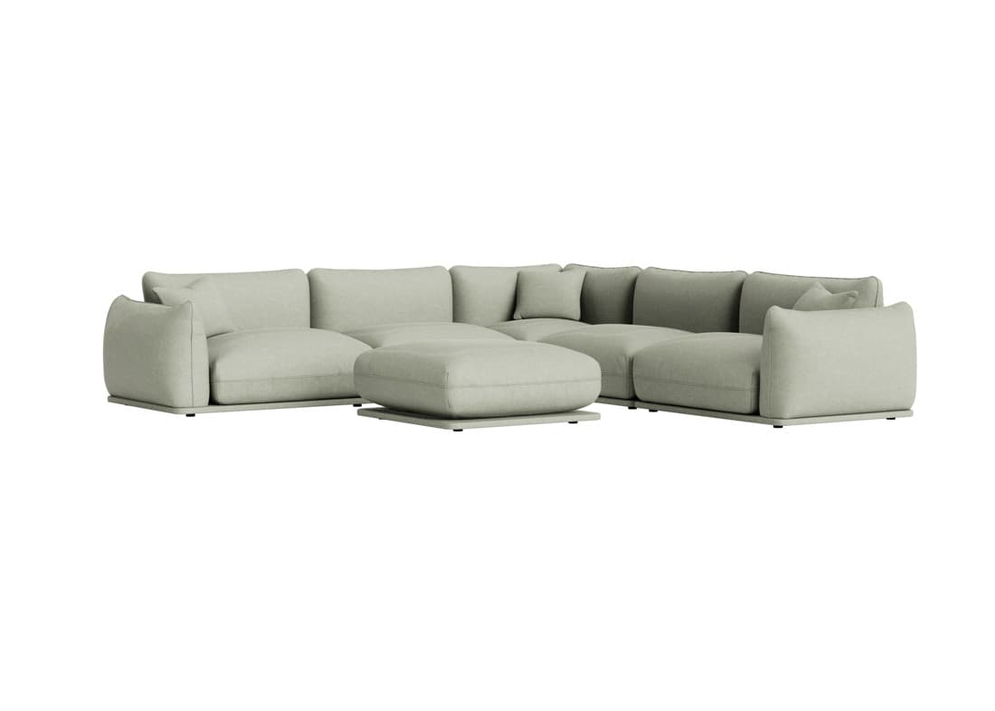 A light sage green modular sectional sofa featuring a low-profile base and plush, rounded upholstered cushions. The sofa is arranged in an L-shape configuration, accompanied by a matching square ottoman placed in front. The design emphasizes comfort and a minimalist contemporary aesthetic, with soft lines and a cohesive color palette. — 3D model