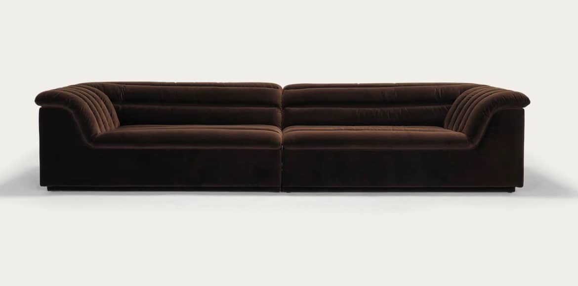A long, three-seater sofa with a channeled design on the backrests and armrests. The sofa appears to… — free GLTF 3D model