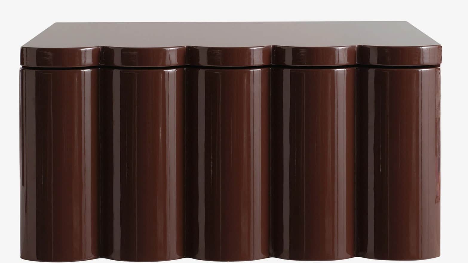 A brown cabinet with a high-gloss finish. The front features a scalloped design with vertical, round… — 3D model