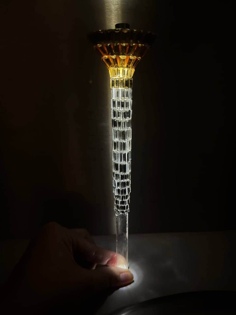 A tall, slender decorative object, likely functioning as a lamp, featuring a prominent faceted clear… — 3D model