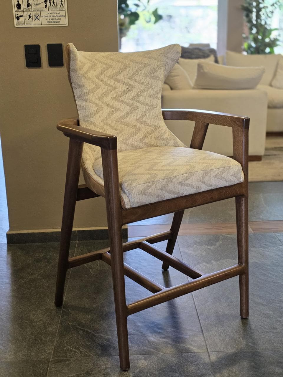 A contemporary counter-height armchair featuring a dark wood frame and fully upholstered seat and back. The upholstery showcases a distinctive beige zig-zag pattern. — 3D model