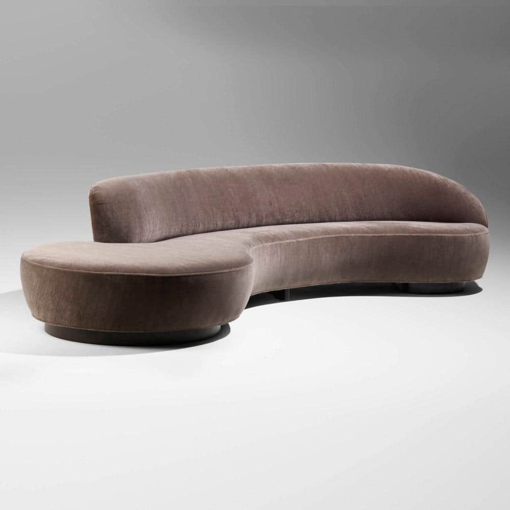 A modern, curvilinear sectional sofa upholstered in a luxurious brownish-grey (taupe) velvet fabric.… — 3D model