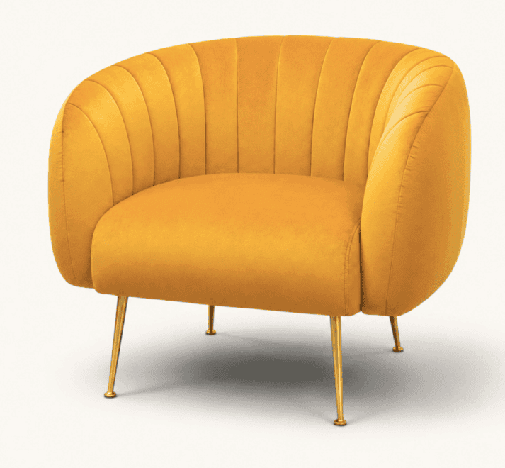 A vibrant mustard yellow velvet accent chair featuring a curved barrel-shaped backrest and integrated armrests. The chair is distinguished by prominent vertical channel tufting across its interior surfaces. It stands on four slender, tapered metal legs with a polished gold finish. — 3D model