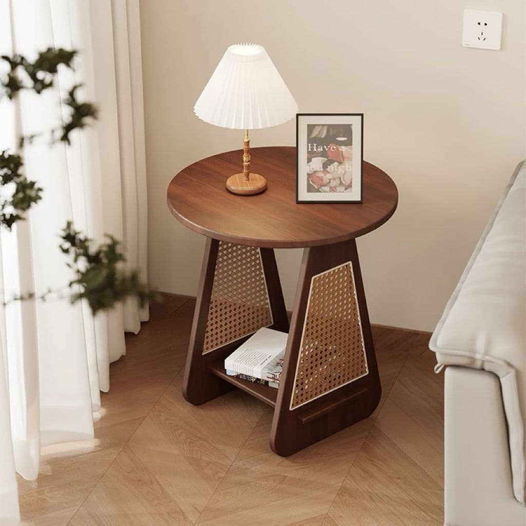 A compact round accent table constructed from dark wood, likely walnut, featuring a cane webbing design integrated into its splayed, triangular leg structure. It includes a lower shelf for storage or display. — 3D model