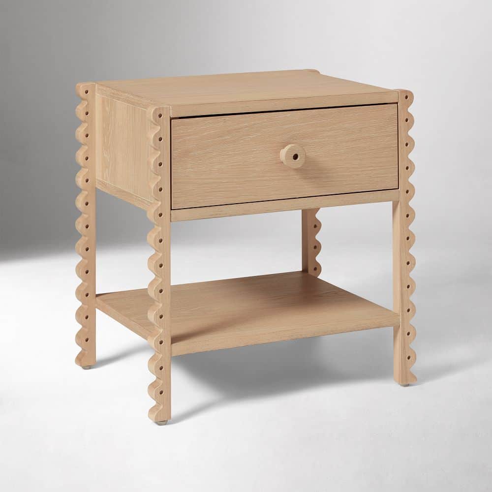 A light-toned wooden nightstand featuring a single drawer and an open lower shelf, distinguished by… — 3D model