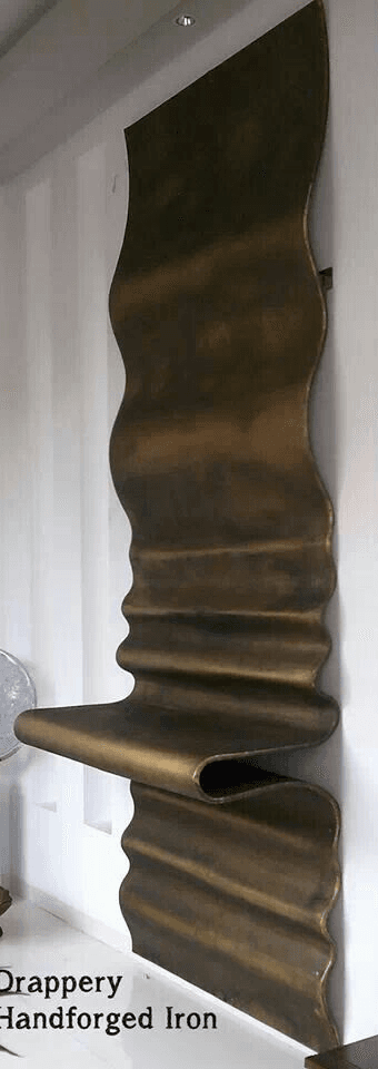 A highly sculptural chair crafted from a single sheet of patinated bronze or a similar metal, featuring an organic, undulating form that creates both the backrest and a cantilevered seat. — 3D model